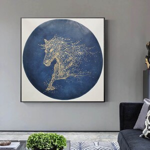 May include: Abstract painting of a gold horse silhouette on a blue circular background. The horse is made up of small gold dots.