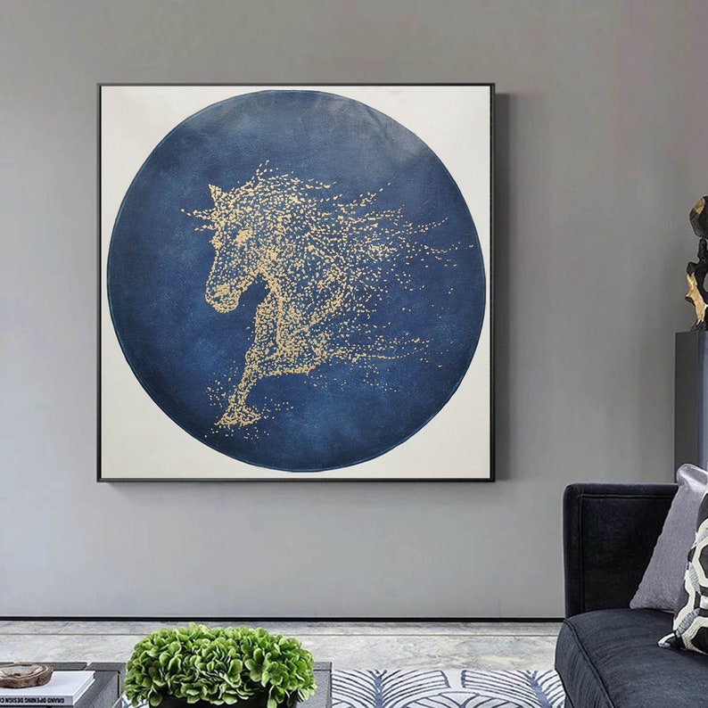 May include: Abstract painting of a gold horse silhouette on a blue circular background. The horse is made up of small gold dots.