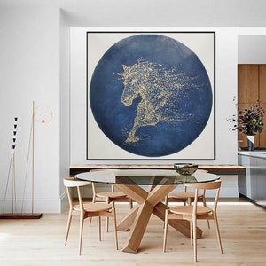 May include: A large abstract painting of a horse in gold on a blue background. The horse is depicted in a circular shape, with its mane and tail flowing in the wind.