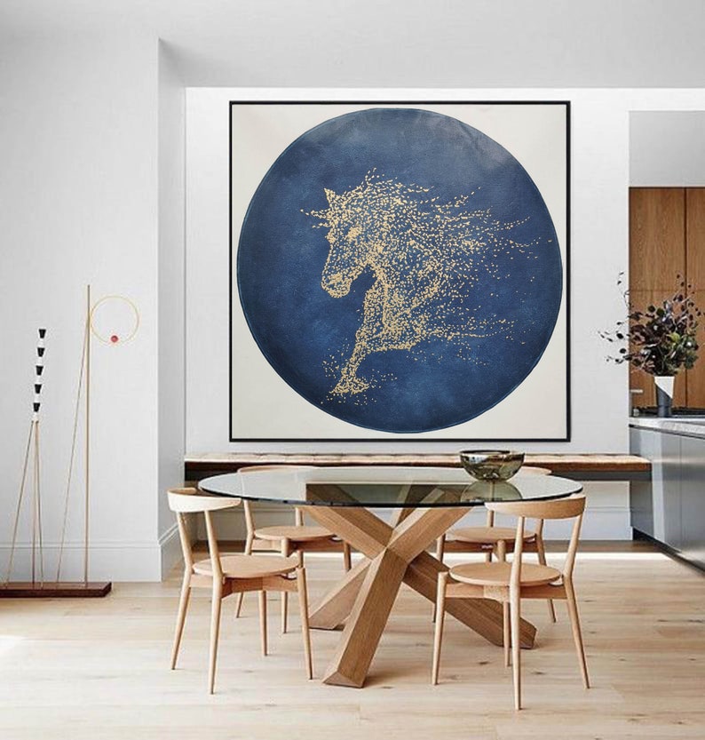 May include: A large abstract painting of a horse in gold on a blue background. The horse is depicted in a circular shape, with its mane and tail flowing in the wind.