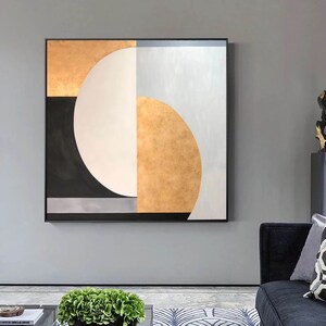 May include: Abstract geometric painting with a large white circle, black and gold accents, and a gray background.