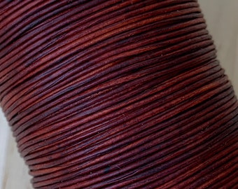 May include: A spool of dark brown leather cord. The cord is tightly wound and has a smooth, polished finish.