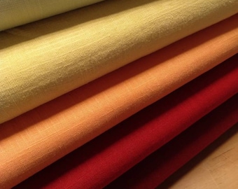 May include: A stack of fabric swatches in various shades of green, yellow, orange, and red. The fabric is a linen blend and has a subtle texture.