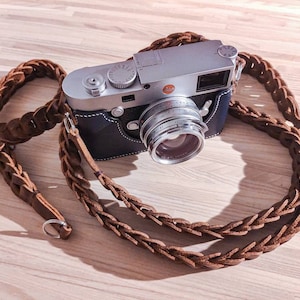 Camera strap made with genuine leather, hand braided and stitch for the classic shooter.