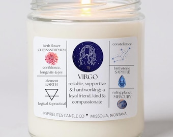 May include: A white candle in a glass jar with a lit flame. The label features the Virgo zodiac sign, birth flower, birthstone, and other astrological details. The text on the label includes "INSPIRELITES CANDLE CO. MISSOULA, MONTANA."