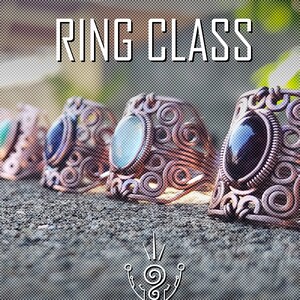May include: Close-up of four rings with different coloured stones. The rings are made of copper wire and have a swirling design. The text "RING CLASS" is at the top of the image. The text "TRACY ARTES 2024" is at the bottom of the image.