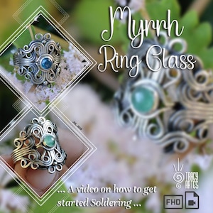 Pode incluir: Close-up de anéis de arame prateado com uma gema central, contra um fundo floral desfocado. Os anéis, rotulados como "Myrrh Ring Glass", apresentam padrões detalhados e giratórios. A imagem também inclui o texto "... A video on how to get started Soldering..."