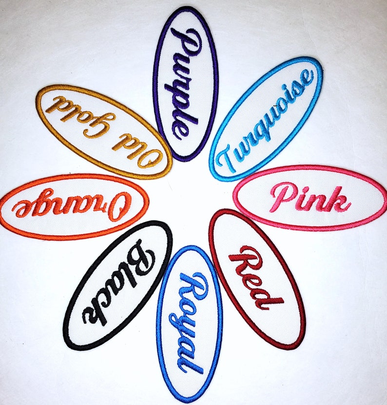 May include: Eight oval-shaped embroidered patches in different colors with the words "Purple", "Old Gold", "Orange", "Black", "Royal", "Red", "Turquoise", and "Pink" written in a cursive font.