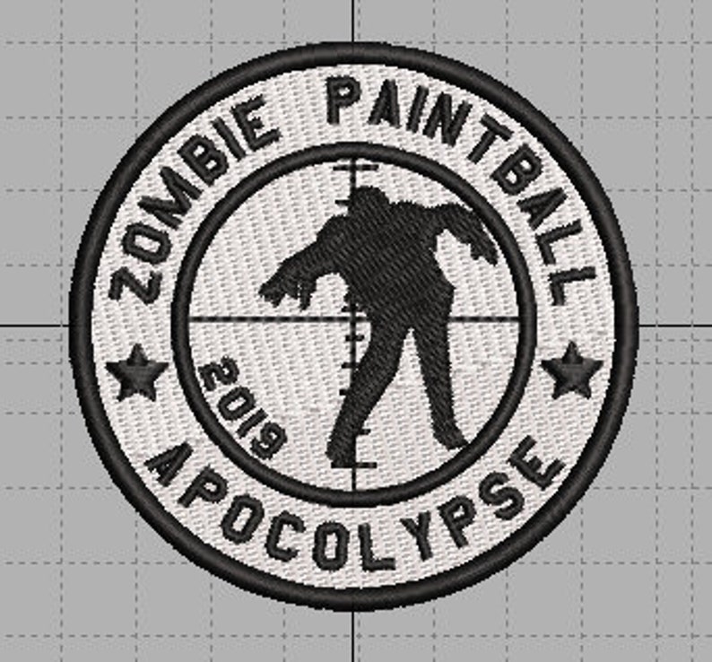 May include: White circular patch with black embroidery. The patch features a zombie silhouette in a crosshair with the text "Zombie Paintball Apocalypse 2019" around the edge.