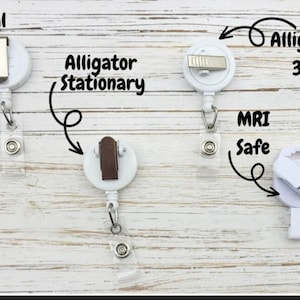 May include: Four different types of retractable badge reels. The first is labeled "Traditional Slide". The second is labeled "Alligator Stationary". The third is labeled "Alligator 360". The fourth is labeled "MRI Safe".