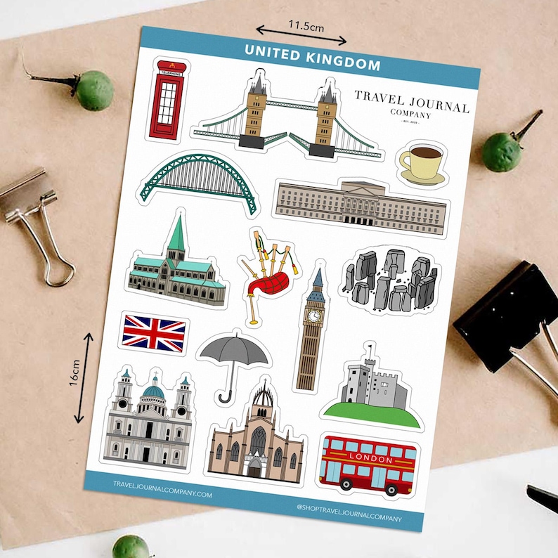 May include: A sheet of stickers featuring iconic United Kingdom landmarks, including a red telephone box, Tower Bridge, Big Ben, and a double-decker bus. The sheet measures 11.5cm x 16cm. The text "UNITED KINGDOM" and "TRAVEL JOURNAL COMPANY" are visible.