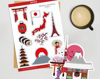 May include: A collection of Japan-themed stickers featuring iconic landmarks and cultural symbols. The stickers include a red torii gate, sushi rolls, a pagoda, Mount Fuji, and the Tokyo Tower. The text "JAPAN" and "TRAVEL JOURNAL COMPANY" are visible.