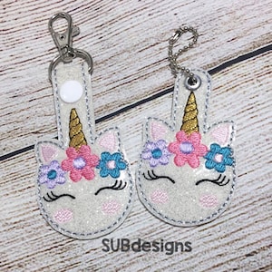 Unicorn face snap tab in the hoop embroidery design round head flowers floral horn vinyl embroider felt feltie eyes eyelashes white pink
