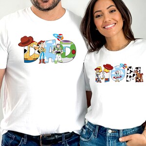 May include: White t-shirts with a Toy Story theme. The shirts feature the words "DAD" and "MOM" spelled out with characters from the movie.