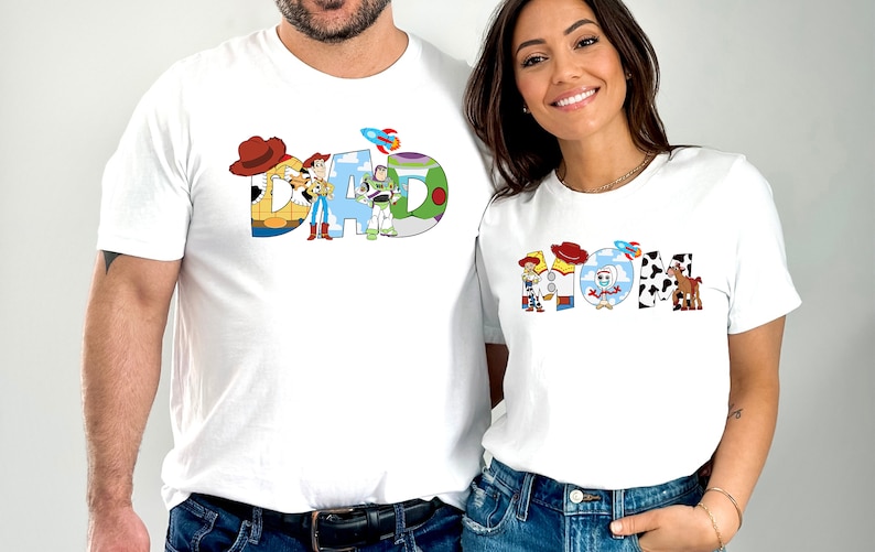 May include: White t-shirts with a Toy Story theme. The shirts feature the words "DAD" and "MOM" spelled out with characters from the movie.