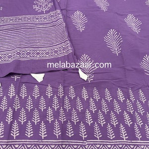 May include: Purple cotton fabric with a white block print design featuring leaves and geometric patterns. The fabric has a subtle sheen and a soft texture.
