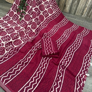 K&ouml;nnte beinhalten: Bordeaux-wei&szlig;es Textil mit sich wiederholendem Blatt- und geometrischem Muster. Der Stoff weist eine Kombination aus vertikalen Streifen und Zickzackmustern auf, mit einem passenden Stoffst&uuml;ck.