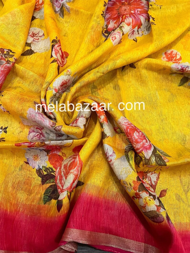 May include: Yellow linen fabric with a floral print. The fabric has a gradient effect, fading from yellow to pink at the bottom. The text "melabazar.com" is printed on the fabric.