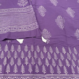 May include: Purple cotton fabric with a white block print design. The fabric features a repeating pattern of leaves and geometric shapes.