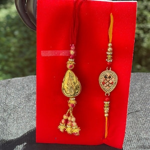 Golden rakhi set for bhai and bhabhi