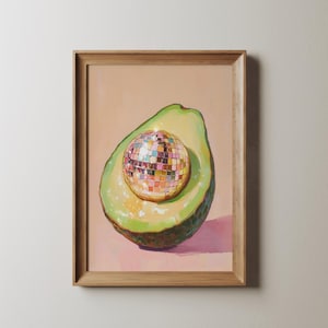 May include: A painting of a halved avocado with a disco ball inside. The avocado is green and the disco ball is gold with mirrored tiles.