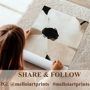 May include: An abstract art print featuring a large black and white floral design on a neutral background. The print is being held by a person, with a rolled-up print visible below. The text "SHARE & FOLLOW" and Instagram handle are at the bottom.