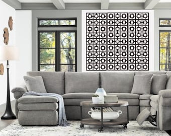 May include: A gray sectional sofa with a chaise lounge in a living room with a geometric patterned wall decor and a round coffee table with a white bowl and books.