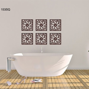 May include: Six brown wooden wall decor panels with a floral design. The panels are arranged in two rows of three. The panels are hanging on a white wall above a white bathtub.
