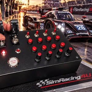May include: A black rectangular sim racing button box featuring two carbon fiber-style paddle shifters, three metal toggle switches, ten red push buttons, and four black rotary knobs with red accents. A silver button labeled ENGINE START is included.