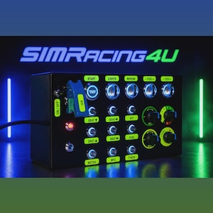 May include: A black rectangular sim racing button box featuring a blue ignition toggle switch, multiple illuminated push buttons, and rotary dials. The panel includes labels such as START, LIGHTS, WIPERS, FUEL, FOV, SEAT, PIT, MOTEC, MFD, and TYRES.
