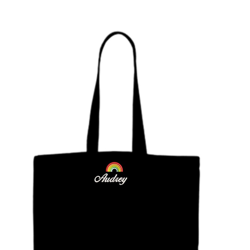 May include: Black tote bag with a rainbow and the name Audrey embroidered on the front.