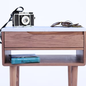 Bedside table, Nightstand, Mid century  with marble top, shelf and upper drawer in solid Walnut.