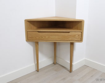 Corner nightstand with shelf and lower drawer in solid Oak or Walnut.