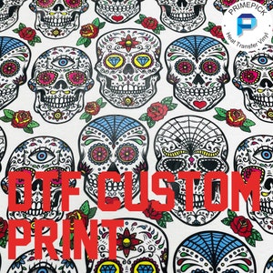 May include: A white background with a repeating pattern of colorful sugar skulls. The text "DTG CUSTOM PRINT" is in red letters across the bottom of the image.