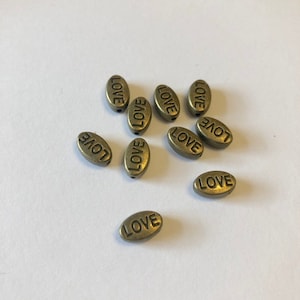 Bronze tone oval beads, love, metal beads