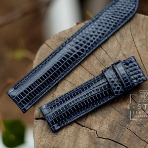 Könnte beinhalten: Zwei dunkelblaue Lederarmbänder mit Kroko-Muster. Die Armbänder liegen auf einer Holzoberfläche. Der Text "I-STIZ LEATHER HANDMADE" ist in der unteren rechten Ecke des Bildes sichtbar.