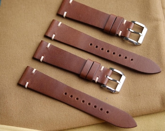 May include: Four brown leather watch straps with white stitching and silver buckles.