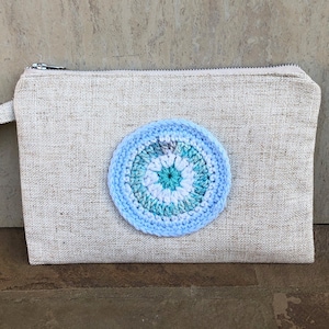 Crochet Evil Eye Mati in Light Blue on Light Brown Woven Material Clutch Bag