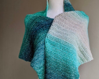 A Lovely soft and long shawl, Hand crotched in Green tones going in to Turquoise and light Grey with a Silver Thread.