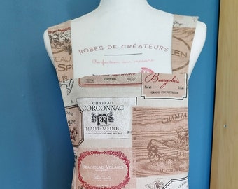 A Home made Japanese style Apron, Spanish Lin/Cotton fabric, Wrap around, Single fabric with a print of Wine growers and brand. Two pockets