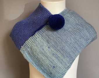 A Lovely Handmade Knitted Soft Baby Poncho in Different Blue tones.