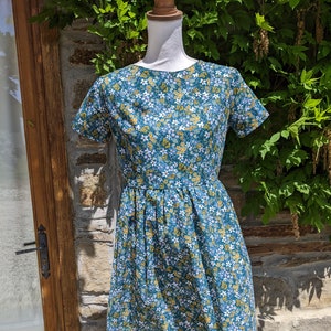 A Lovely Home made Liberty Dress in 100% Cotton in Teal with White, Lilac and Mustard Yellow flowers.