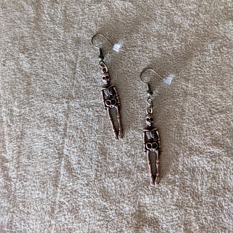 Earrings-dangling bronze colored skeletons