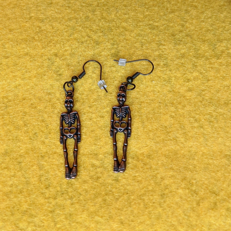 Earrings-dangling bronze colored skeletons
