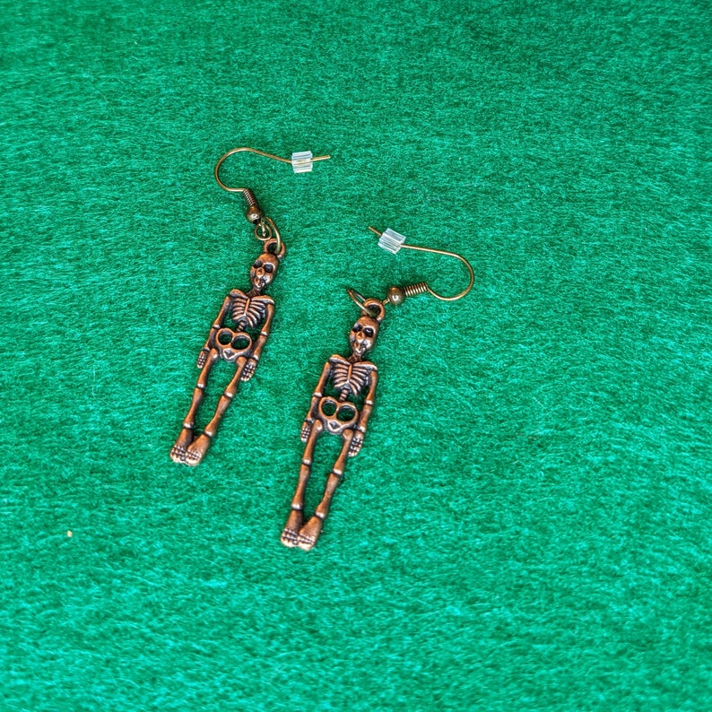 Earrings-dangling bronze colored skeletons