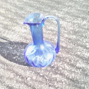 Pretty Blue Heavy Glass Pitcher With A Long Handle.