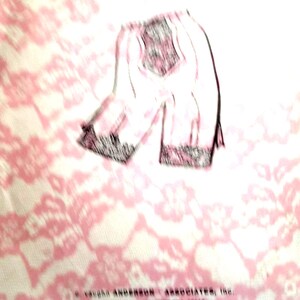 May include: A pink and white patterned fabric with a black and white illustration of a pair of pants. The text "C. Vaughn Anderson Associates, Inc. Saint Paul, Minnesota 55116 © 1980" is printed on the fabric.