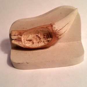 Reproduction Of An Alaska Brown Bear Tooth, Carv With Snow Scene Cabin.