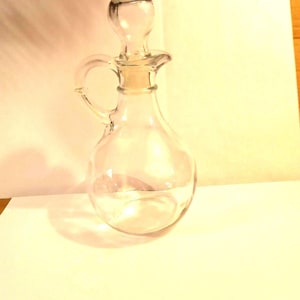 Newer Glass Cruet,  Clear Glass With Plastic Lined Glass Stopper.
