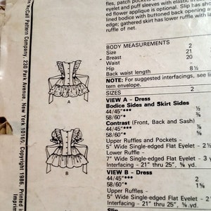 May include: Sewing pattern for a children's dress and slip. The pattern includes instructions for making a dress with a square neckline, upper ruffles, patch pockets, and a lower ruffle. The slip has a gathered skirt with a lower ruffle. The pattern includes measurements for sizes 2, 20, and 21.